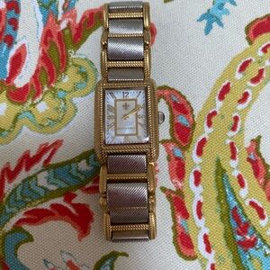 Judith Ripka gold and silver tone watch with mother of  pearl watch face.